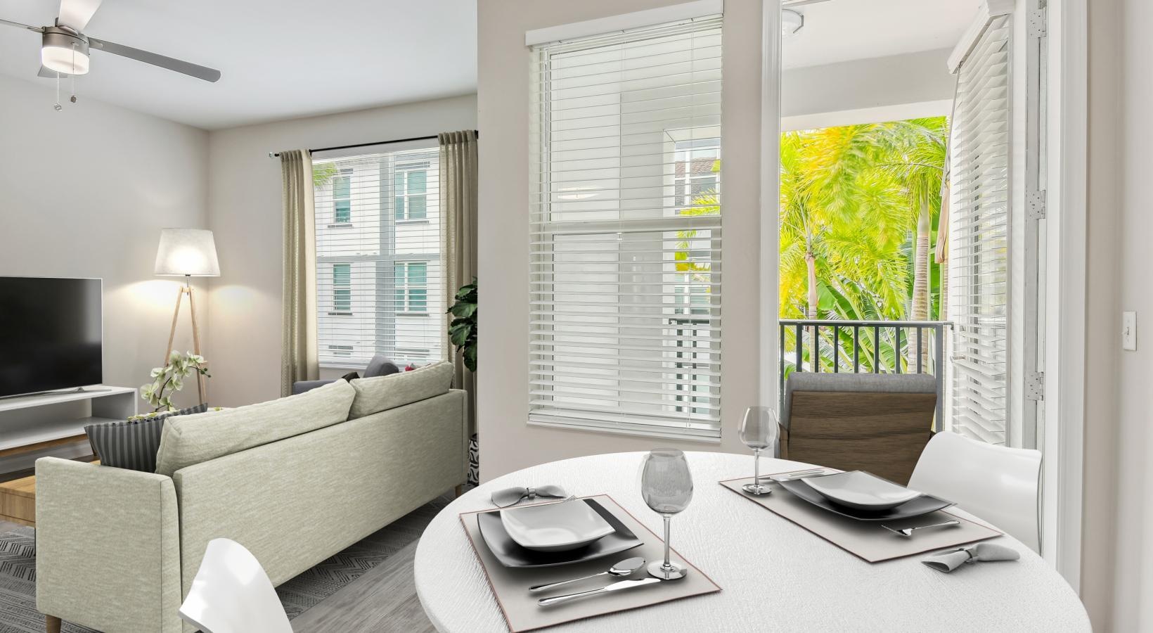 Settle into comfort at Amelia Westshore a living room with a table and chairs