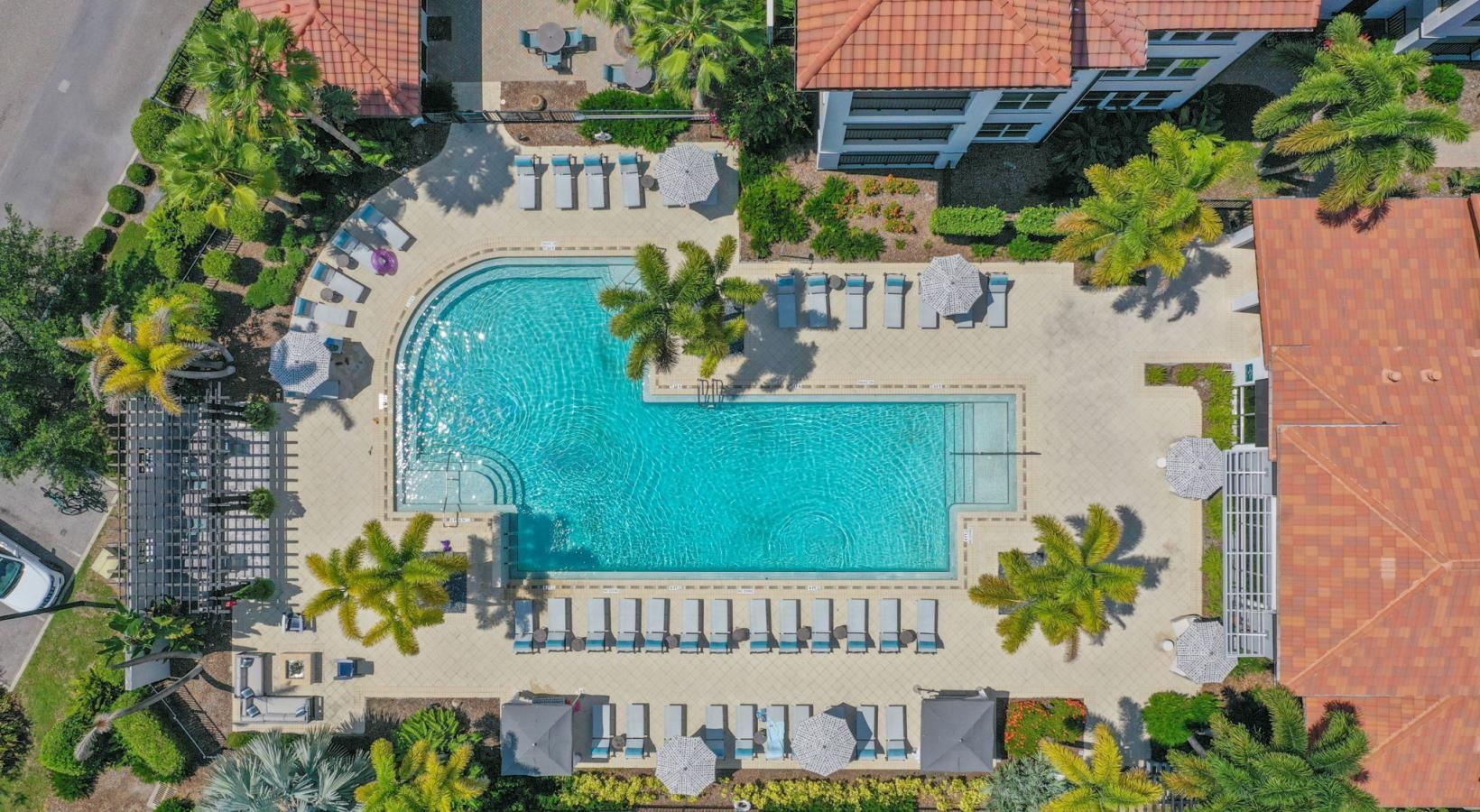 Relax and unwind poolside a building with a pool