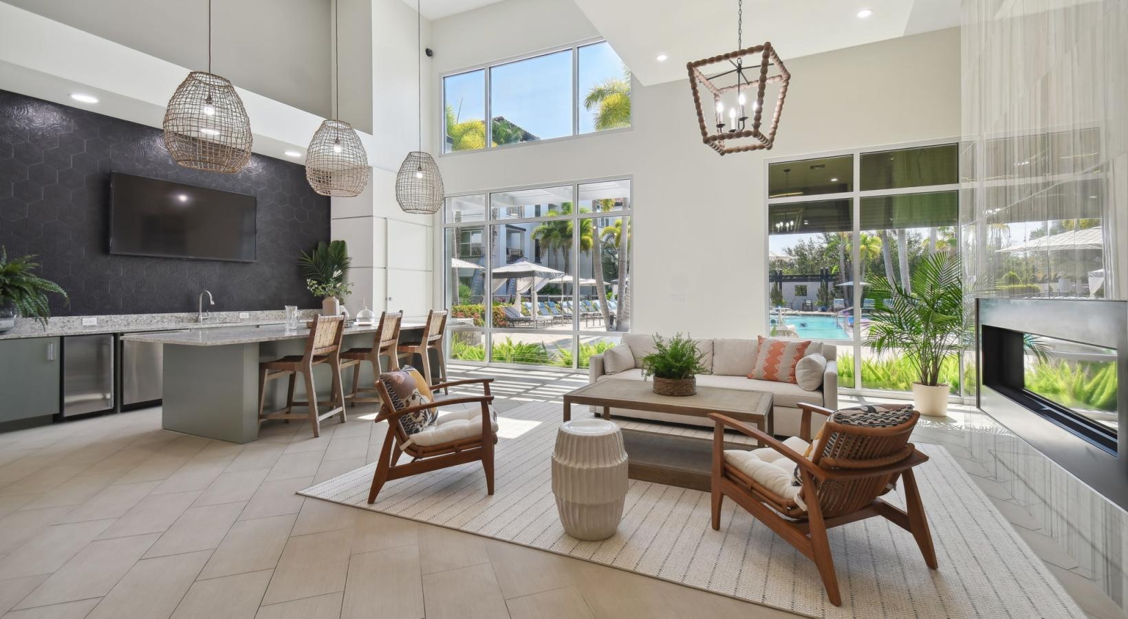 Settle into comfort at Amelia Westshore a room with a table chairs and a tv