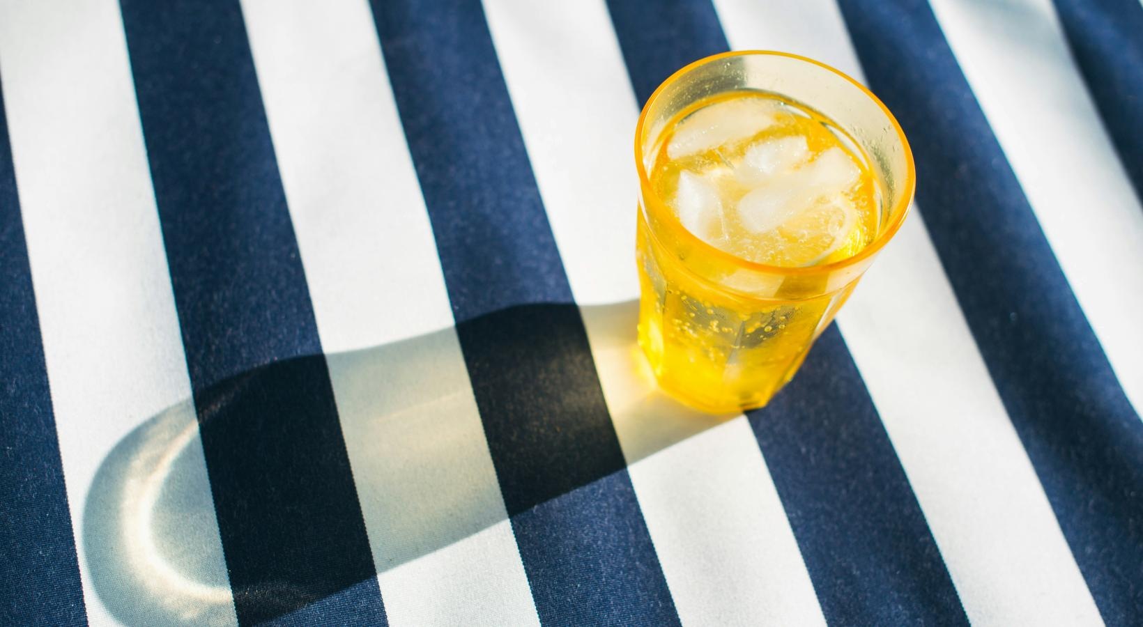 The essence of exceptional living a glass of water on a striped surface