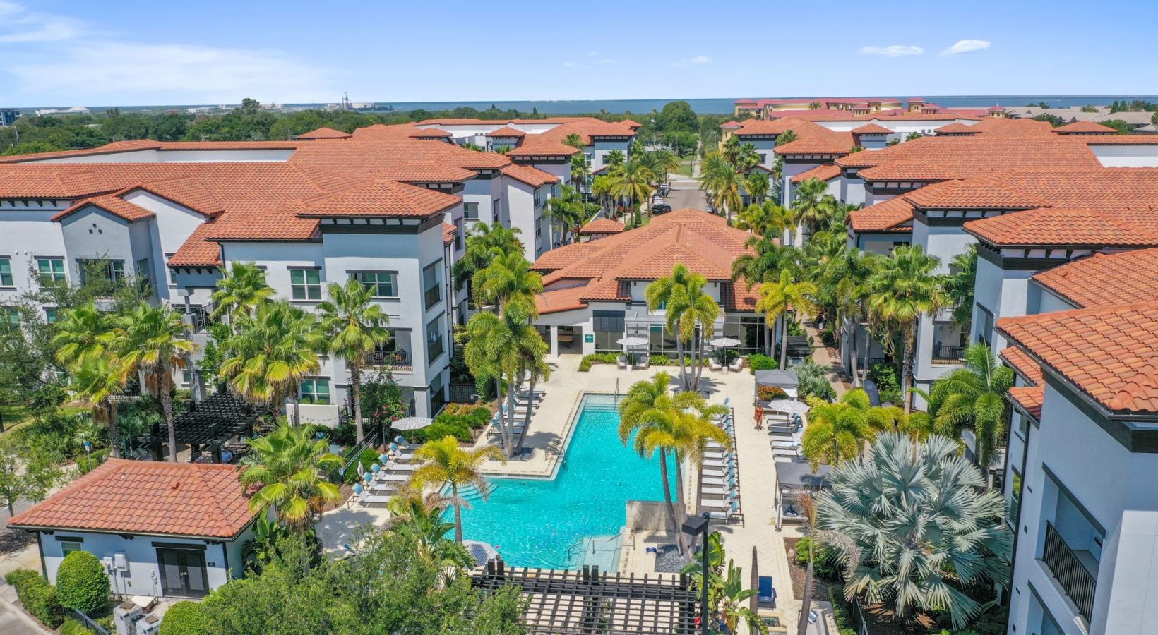 Settle into comfort at Amelia Westshore a pool surrounded by buildings - South Tampa FL luxury apartments Amelia Westshore