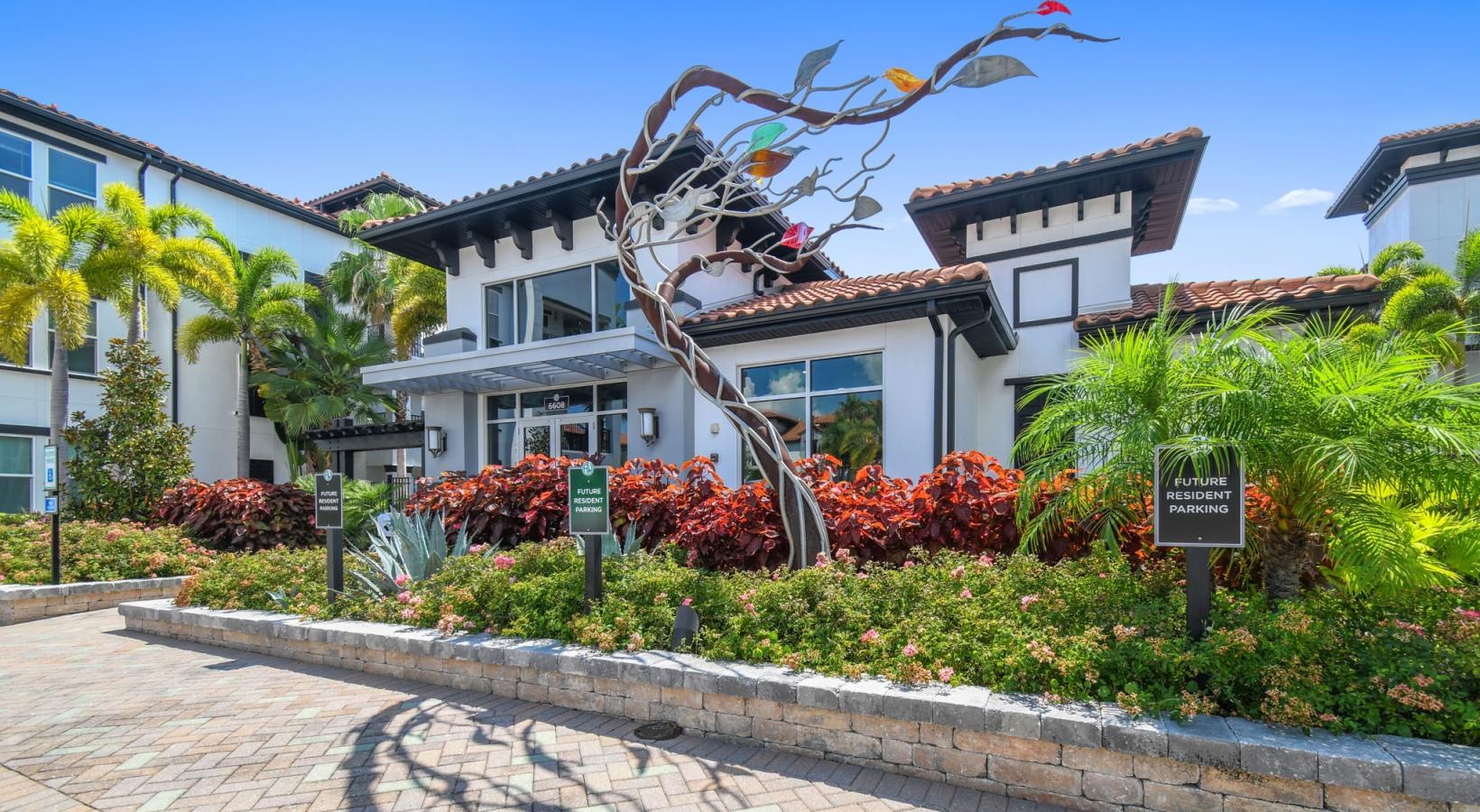 Settle into comfort at Amelia Westshore a building with a garden in front of it